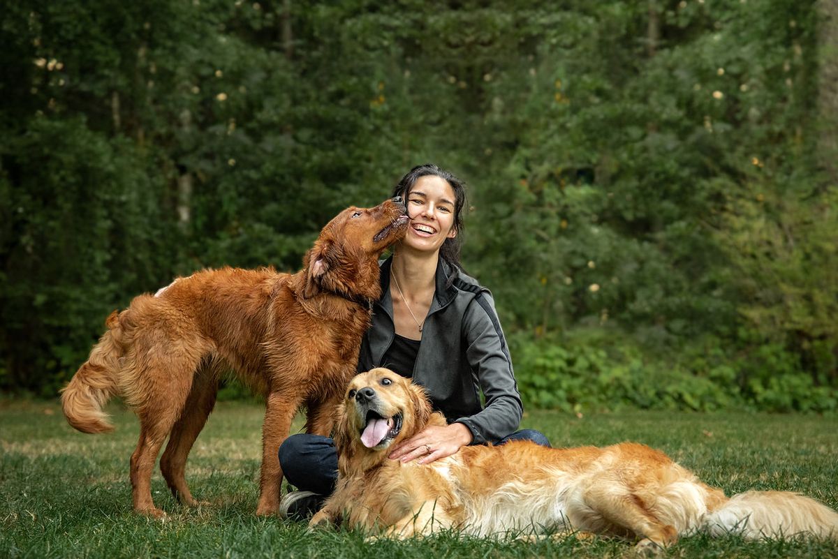 A happy first-time emotional support animal owner cuddling their dog with an official ESA letter in hand.