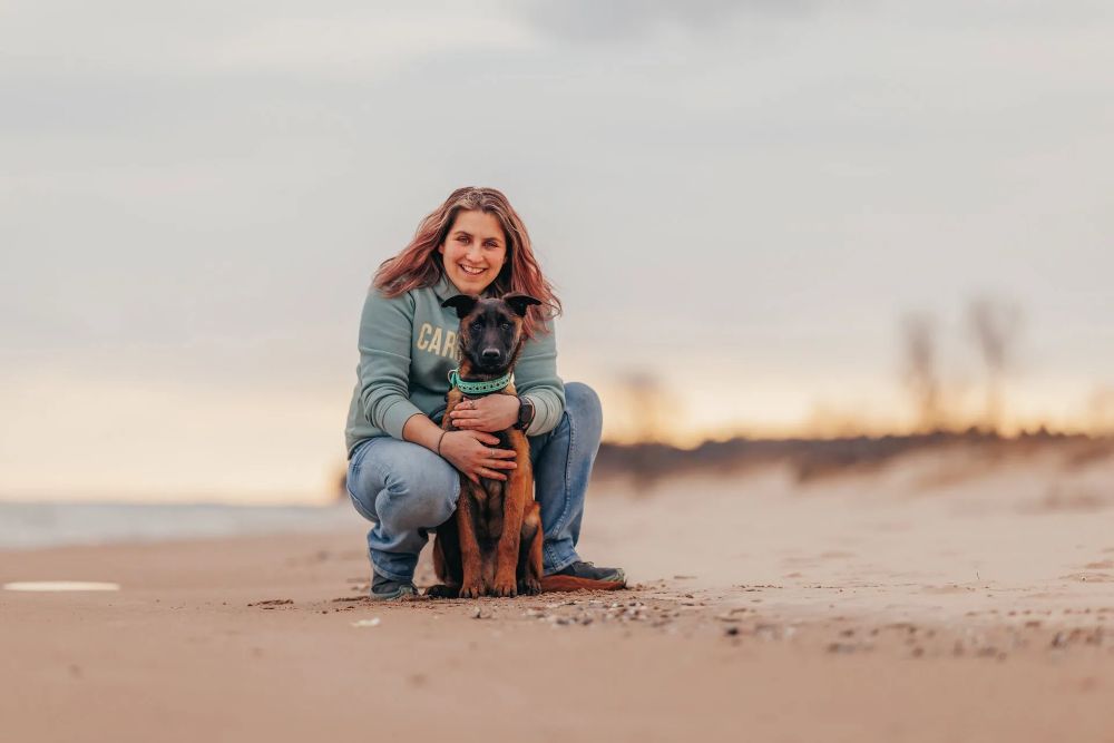A person happily petting their emotional support dog at home, symbolizing comfort and quick access to ESA housing rights.